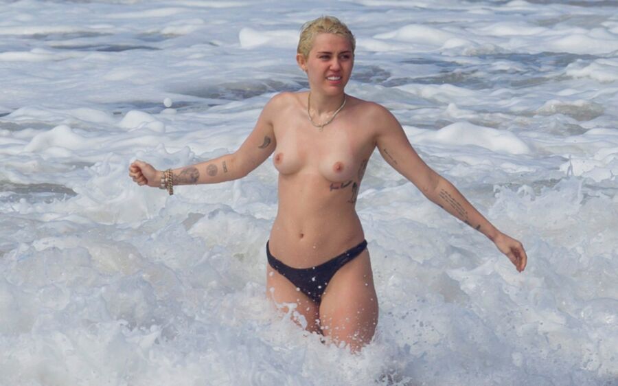 Free porn pics of Miley Cyrus Topless on Hawaii 19 of 44 pics
