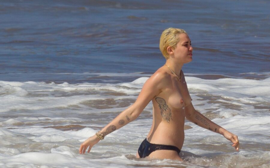 Free porn pics of Miley Cyrus Topless on Hawaii 18 of 44 pics