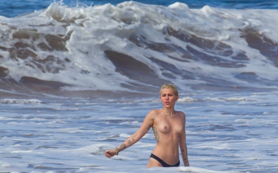 Free porn pics of Miley Cyrus Topless on Hawaii 23 of 44 pics