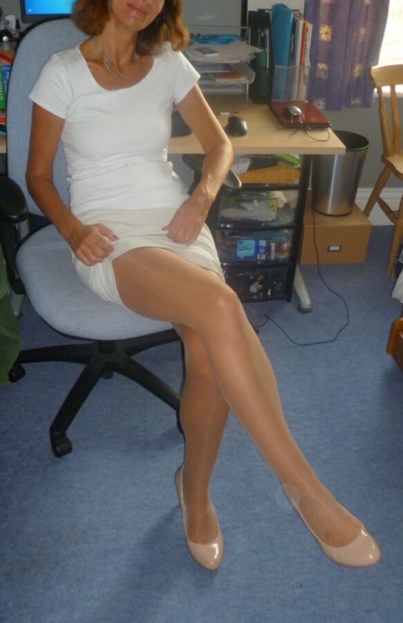 Free porn pics of My shy wife poses before work in tan tights and heels 5 of 8 pics