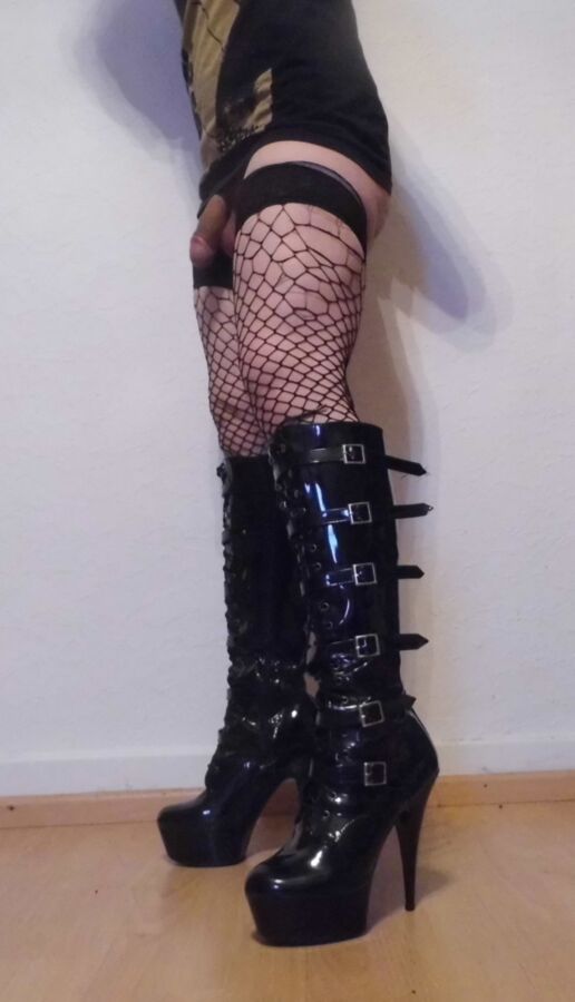 Free porn pics of Crossdressing Boots And Torn Fishnet Stockings 5 of 9 pics