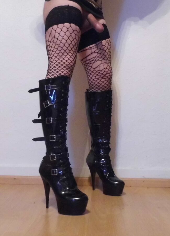Free porn pics of Crossdressing Boots And Torn Fishnet Stockings 3 of 9 pics